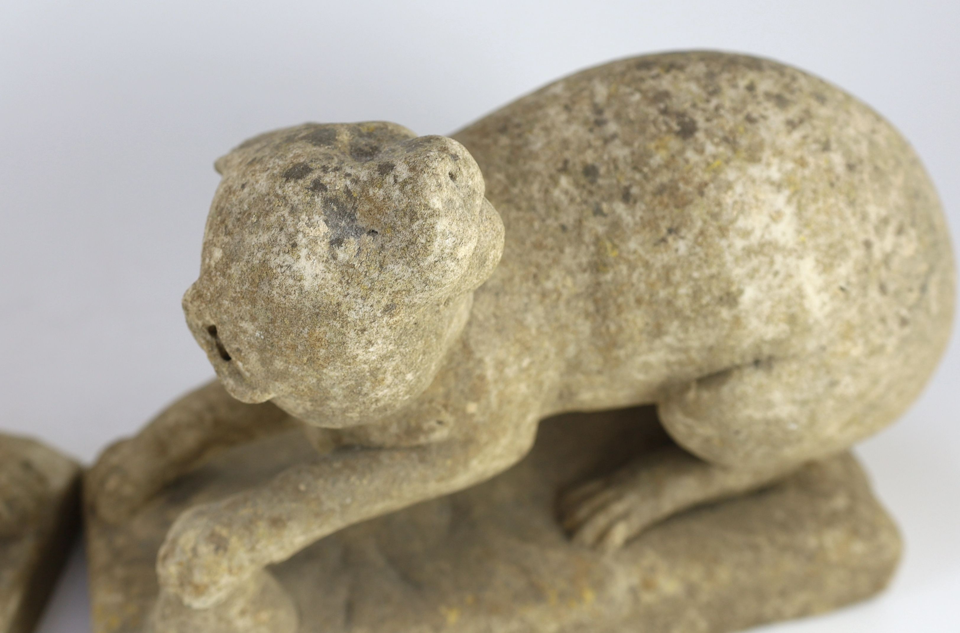 A pair of 19th century carved marble models of crouching cats, width 32cm, depth 12cm, height 22cm